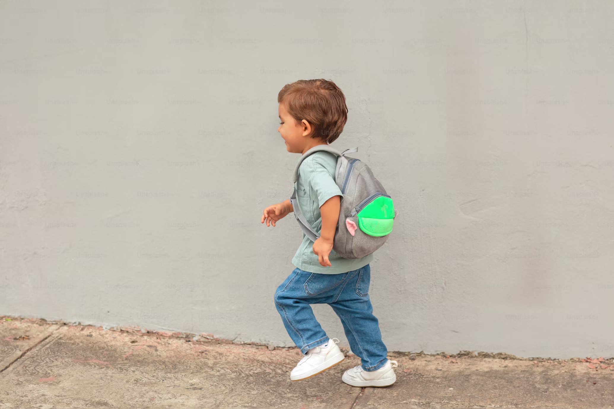 Toddler with a backpack walking outdoors